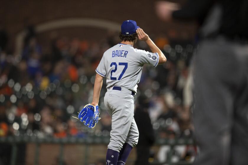 Los Angeles Dodgers starting pitcher Trevor Bauer gestures to the crowd as he's pulled for a reliever during the seventh inning of a baseball game against the San Francisco Giants, Friday, May 21, 2021, in San Francisco. (AP Photo/D. Ross Cameron)