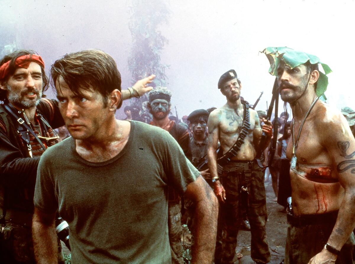 Dennis Hopper), left, Martin Sheen, foreground, and Frederic Forrest in "Apocalypse Now,."