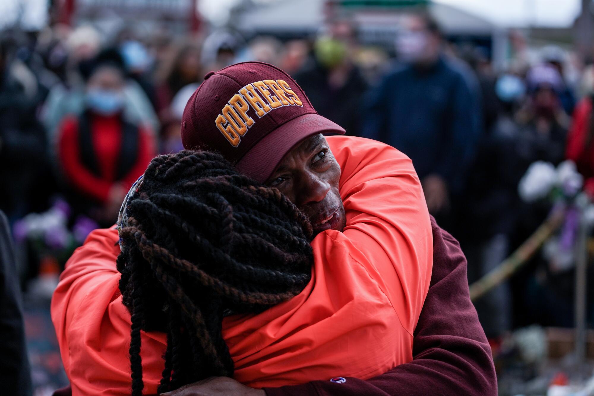 People hug on the street. 