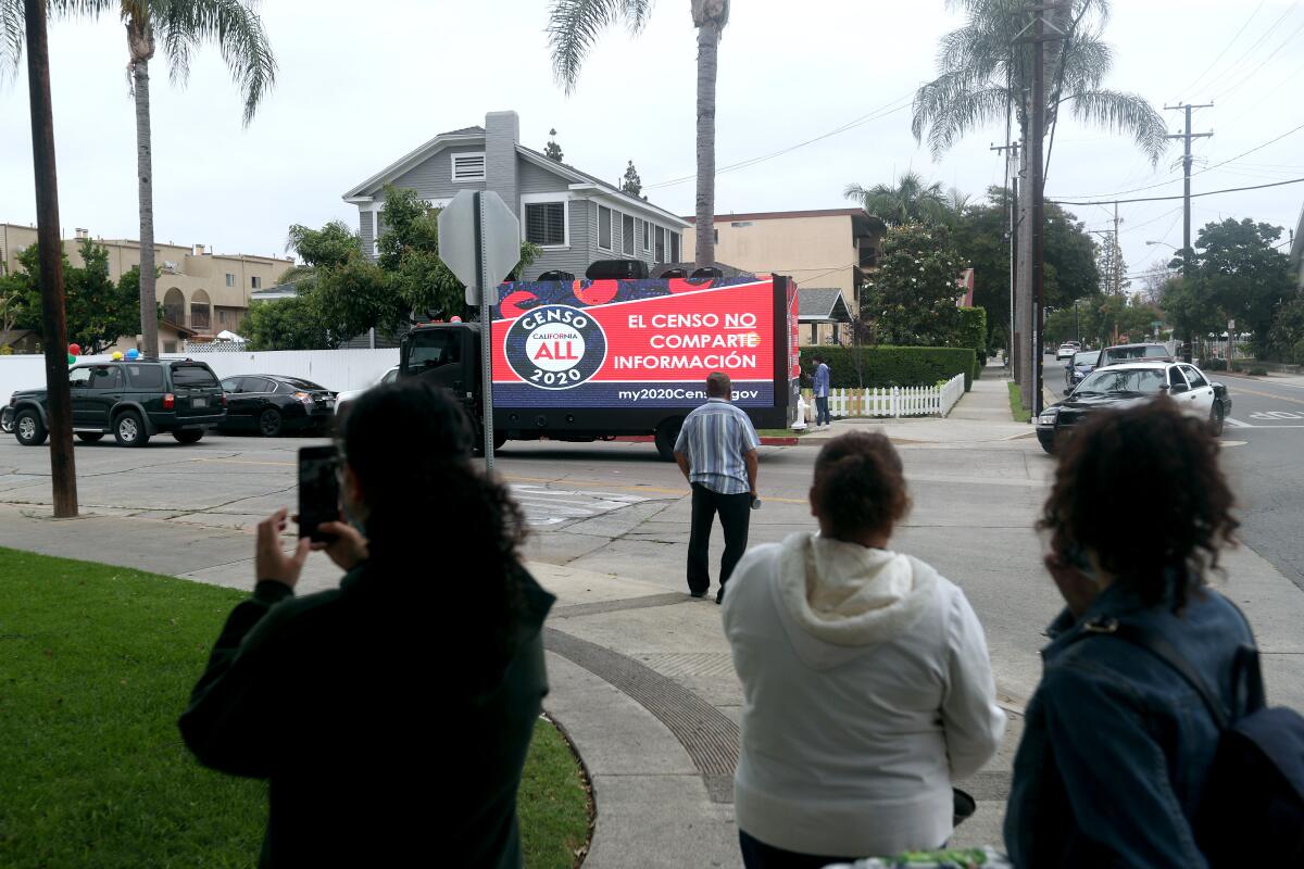 People stopped on the street to see the County of Orange Census campaign