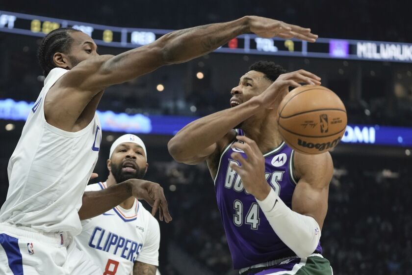 Los Angeles Clippers' Kawhi Leonard knocks the ball from Milwaukee Bucks' Giannis Antetokounmpo during the first half of an NBA basketball game Thursday, Feb. 2, 2023, in Milwaukee. (AP Photo/Morry Gash)