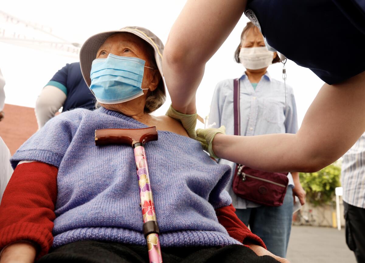 A woman gets a shot.