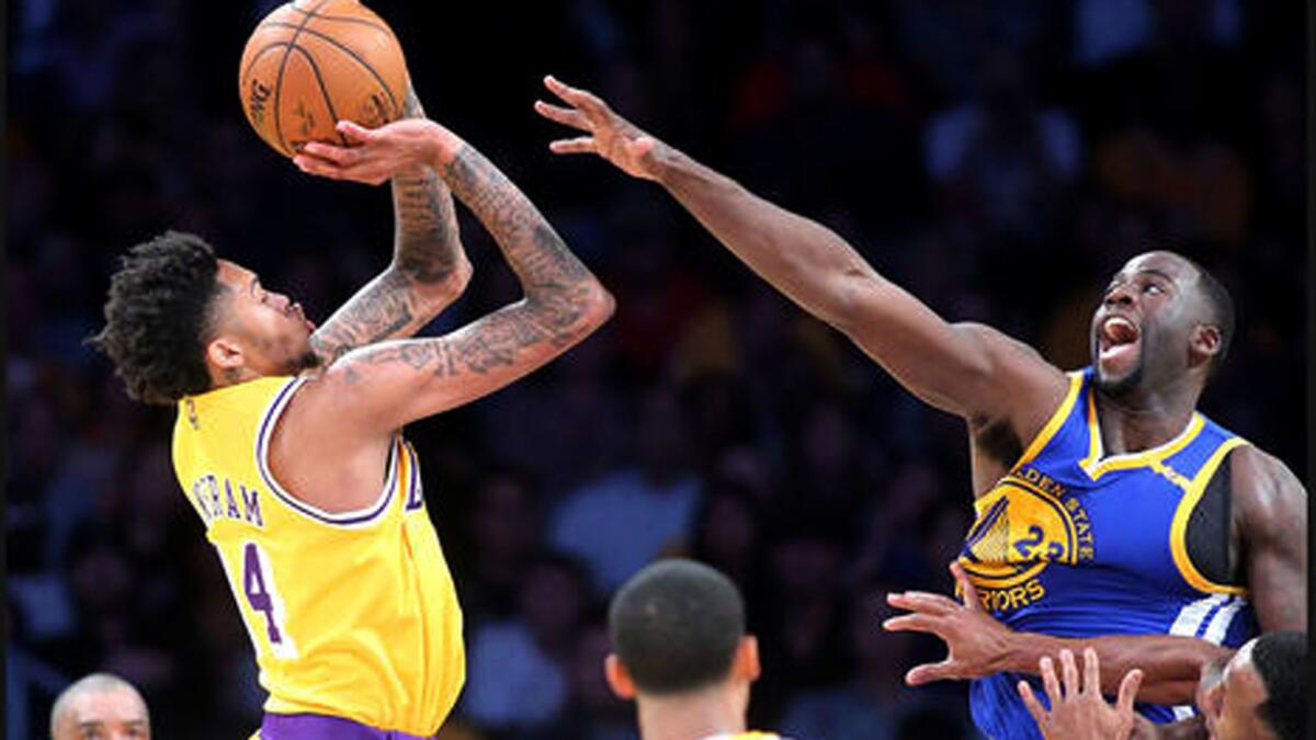 Lakers forward Brandon Ingram scores a clutch basket over Warriors forward Draymond Green in the second half on Friday.