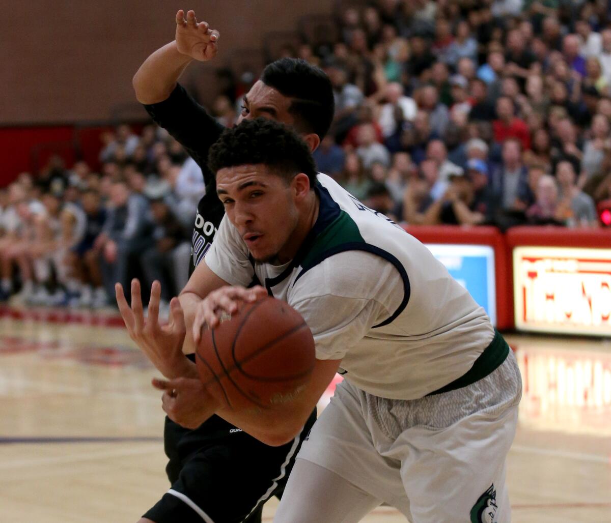 Chino Hills forward LiAngelo Ball fights for control of the ball against Foothills Christian guard Luis Salgado in the first half.
