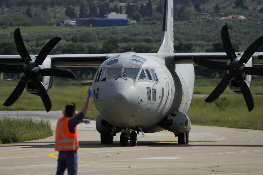 A military plane carrying evacuees from Sudan arrive at Tanagra air base, north of Athens on Wednesday, April 26, 2023. Sixteen Greeks and one Cypriot arrived in Greece after being evacuated from Sudan. (AP Photo/Thanassis Stavrakis)