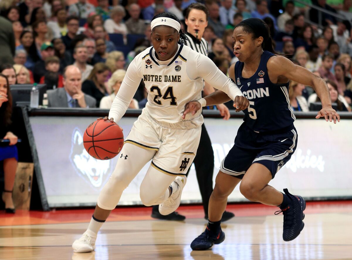 Notre Dame's Arike Ogunbowale, left, is defended by UConn's Crystal Dangerfield during the second quarter in the semifinals of the NCAA Women's Final Four on Friday in Tampa, Fla.