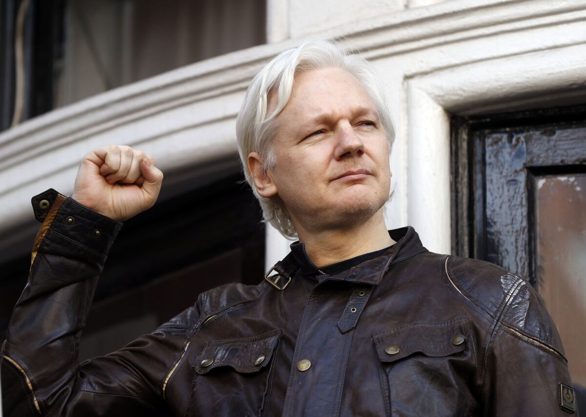 FILE - In this Friday May 19, 2017 file photo, Julian Assange greets supporters outside the Ecuadorian embassy in London. Britain’s High Court on Wednesday July 7, 2021, has granted the U.S. government permission to appeal a decision that WikiLeaks founder Julian Assange cannot be sent to the United States to face espionage charges. (AP Photo/Frank Augstein, File)