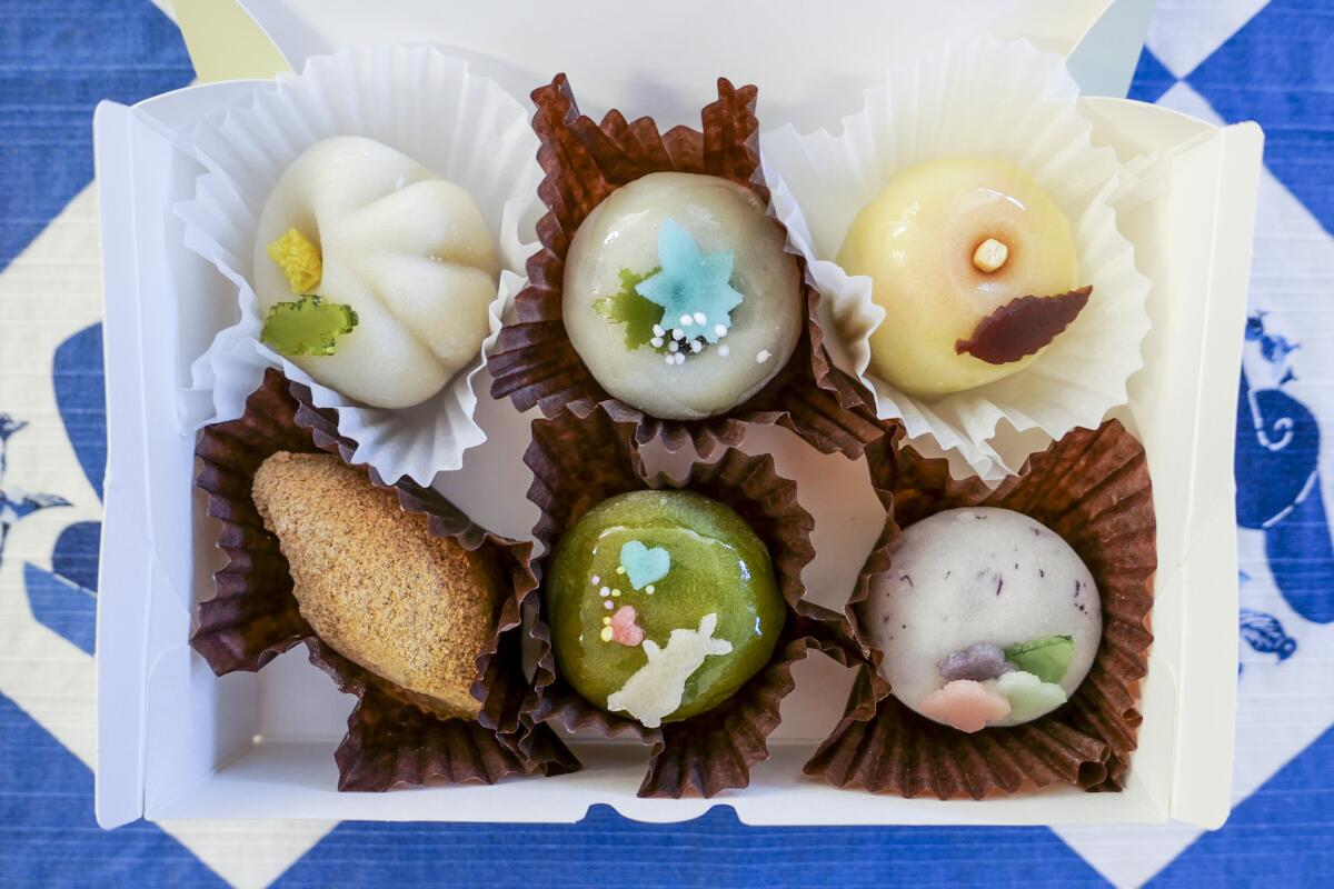 A box of six decorated mochi in ruffled paper cups