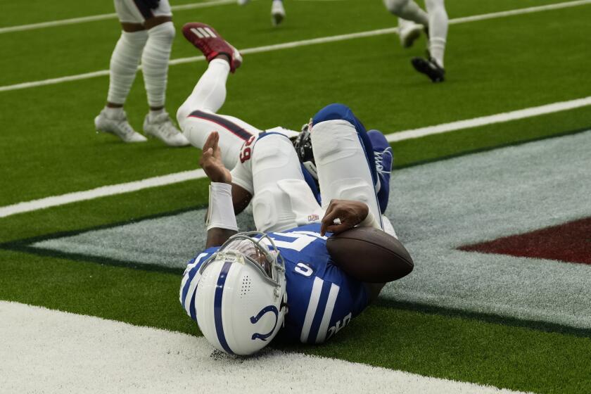 Indianapolis Colts quarterback Anthony Richardson (5) falls to ground after rushing for a touchdown against the Houston Texans during the first half of an NFL football game Sunday, Sept. 17, 2023, in Houston. (AP Photo/David J. Phillip)