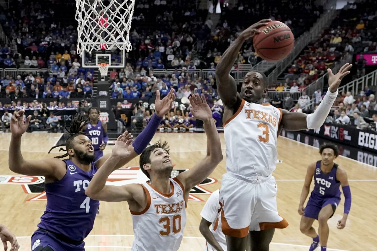 Texas guard Courtney Ramey (3) gets a rebound during the first half of an NCAA college basketball game against TCU in the quarterfinal round of the Big 12 Conference tournament in Kansas City, Mo., Thursday, March 10, 2022. (AP Photo/Charlie Riedel)