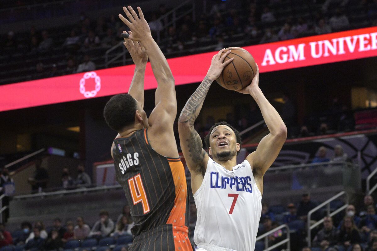 Clippers guard Amir Coffey goes up for a shot in front of Orlando Magic guard Jalen Suggs.