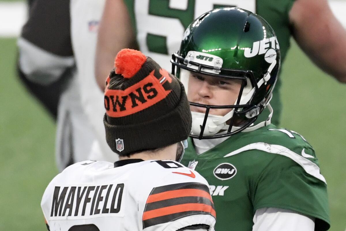 FILE - New York Jets quarterback Sam Darnold talks with Cleveland Browns quarterback Baker Mayfield (6) after the Jets defeated the Browns 23-16 in an NFL football game Sunday, Dec. 27, 2020, in East Rutherford, N.J. The Carolina Panthers now have two of the top three overall picks from the 2018 NFL draft on their roster. The big question is which one of them will start for them this season at quarterback. (AP Photo/Bill Kostroun, File)