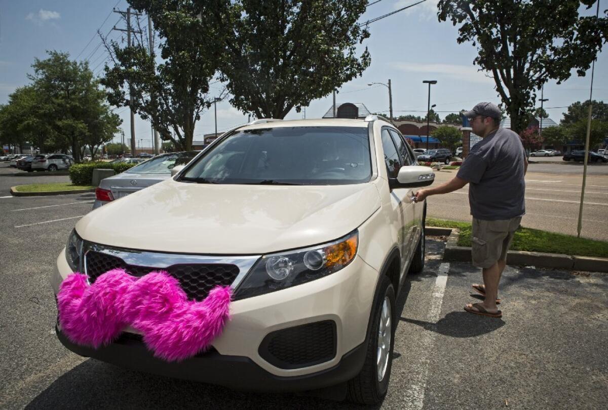 His car adorned with the trademark pink mustache, Lyft driver Geoffrey Frisch gets in is vehicle in Memphis, Tenn., where the city has cracked down on services like Lyft. Lyft and Uber are also said to be using dirty tactics against each other.