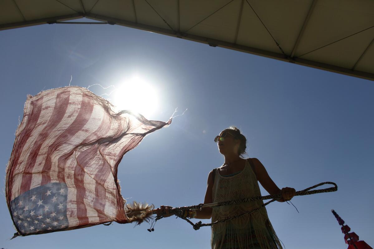 INDIO, CA -- APRIL 20, 2013--Sarah Weston,28, from Venice, attending her first festival, used her American Flag scarf as a flag while dancing to Allen Stone, on day two, of the second week, of the Coachella Valley Music and Arts Festival, at the Empire Polo Club in Indio, April 20, 2013.