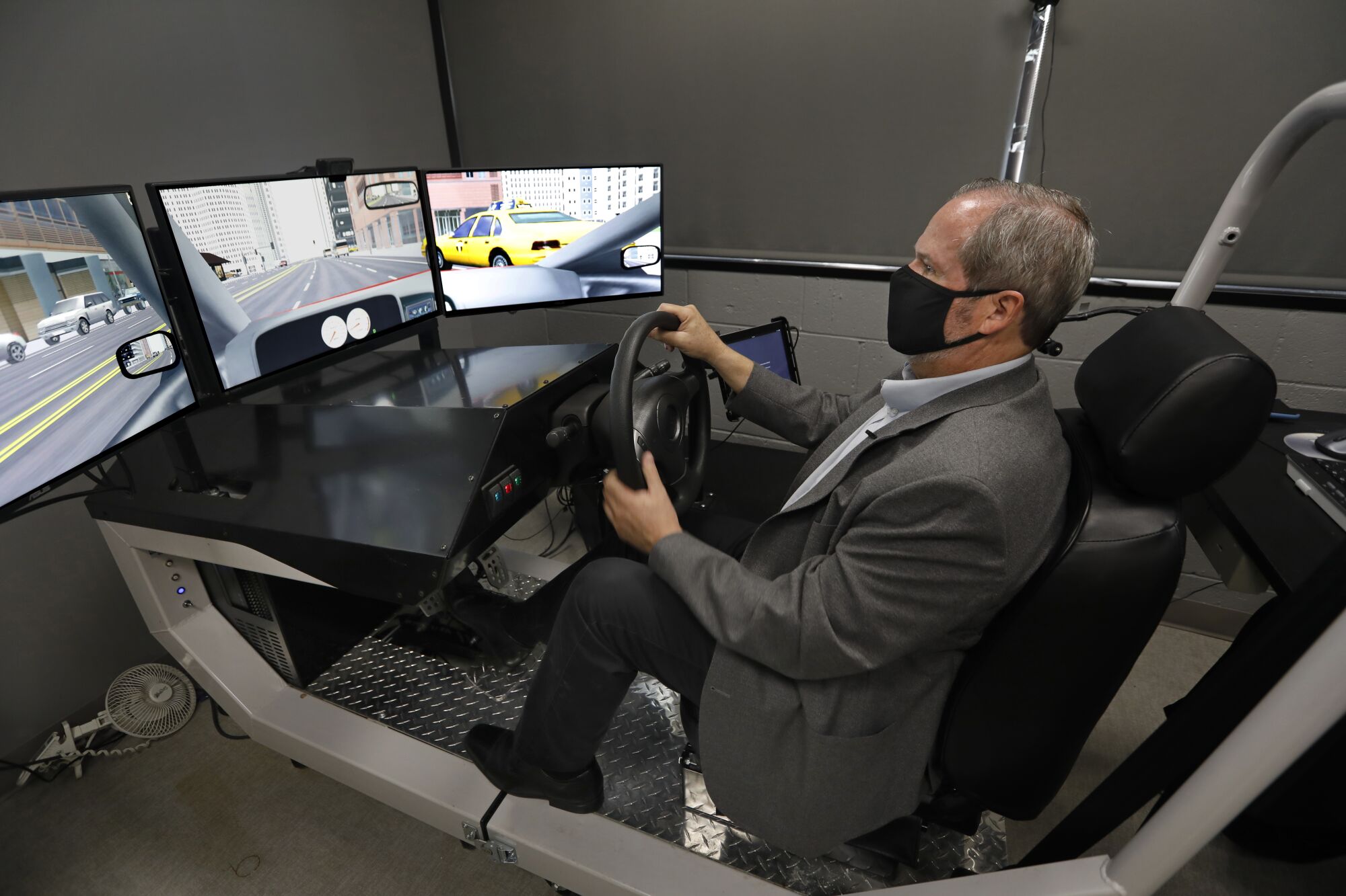 Thomas D. Marcotte demonstrates a driving simulator 