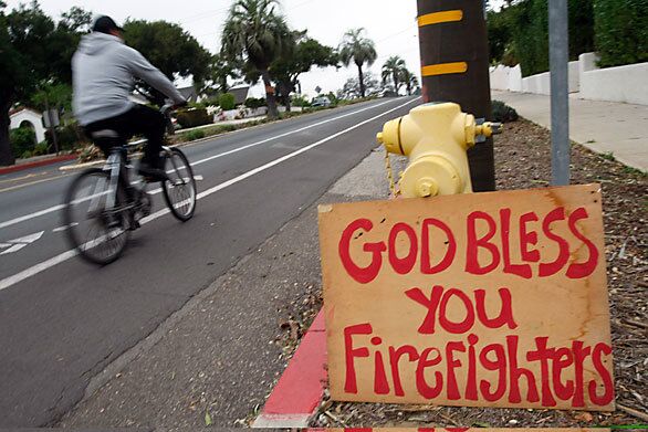 A sign made by Debbie Trauntvein and her son Evan offering their gratitude is displayed at a fire hydrant on State Street.