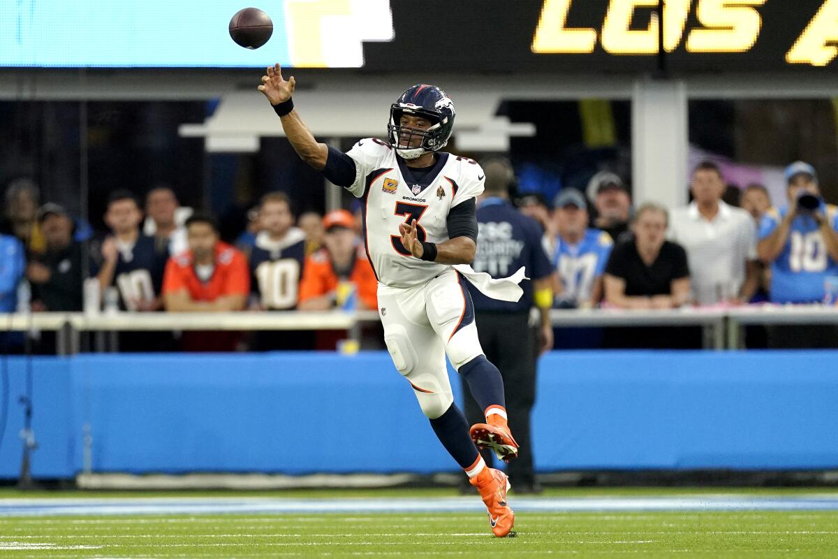 Denver Broncos quarterback Russell Wilson throws against the Chargers in the first half.