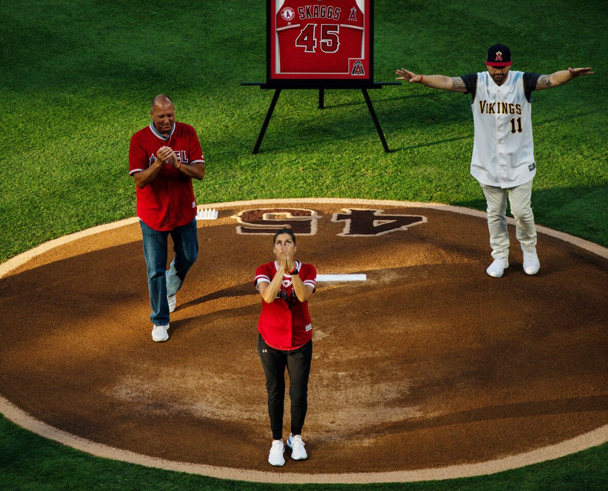 Debbie Hetman, mother of the late Tyler Skaggs, looks up after throwing the first pitch.