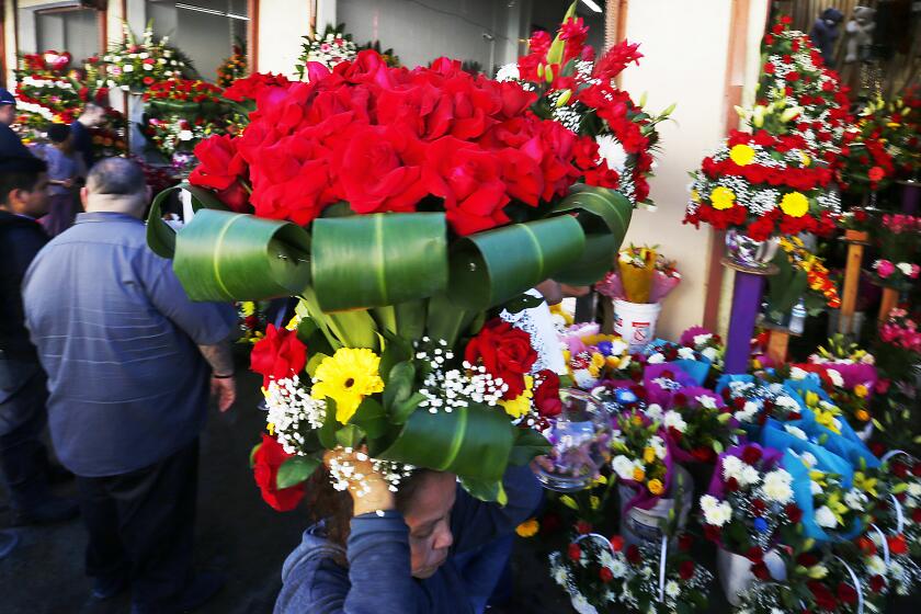 LOS ANGELES, CALIF. - FEB. 14, 2020. Valentines Day sales are brisk along San Pedro Street in the Los Angeles downtown flower market on Friday, Feb. 14, 2020. (Luis Sinco/Los Angeles Times)