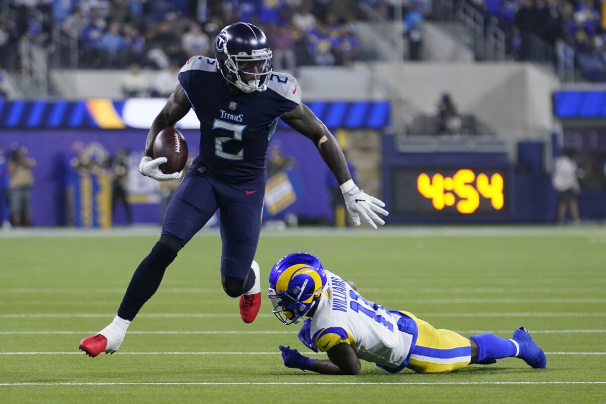 Tennessee Titans wide receiver Julio Jones, left, gets away from Los Angeles Rams defensive back Darious Williams during the first half of an NFL football game Sunday, Nov. 7, 2021, in Inglewood, Calif. (AP Photo/Marcio Jose Sanchez)