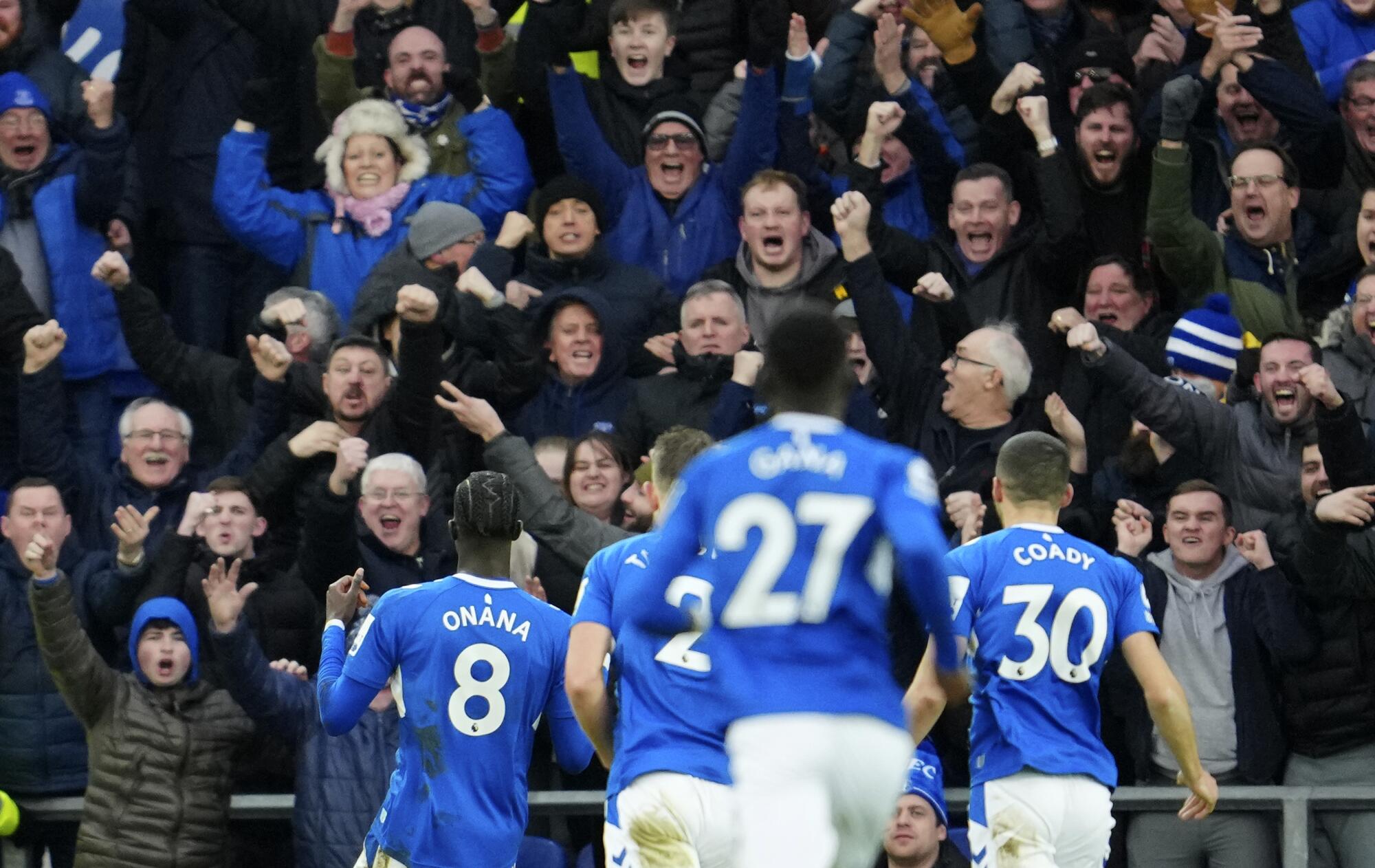 Everton fans cheer after Amadou Onana, left, scores against Southampton on Jan. 14.