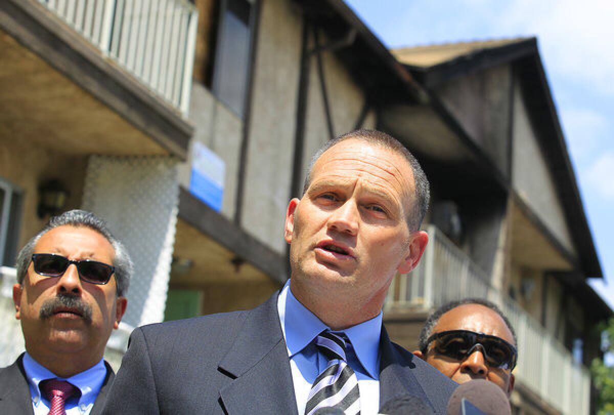 United Firefighter of Los Angeles City leader Frank Lima, center, speaks during a news conference outside a heavily damaged apartment building on Riverton Avenue in North Hollywood last spring.