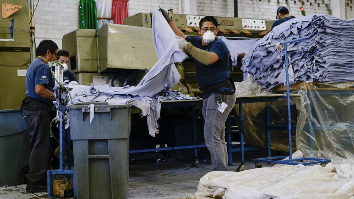 A worker processes hides in a leather tannery in Guanajuato. Surging demand for auto upholstery has revived the region's historic yet faltering leather industry.