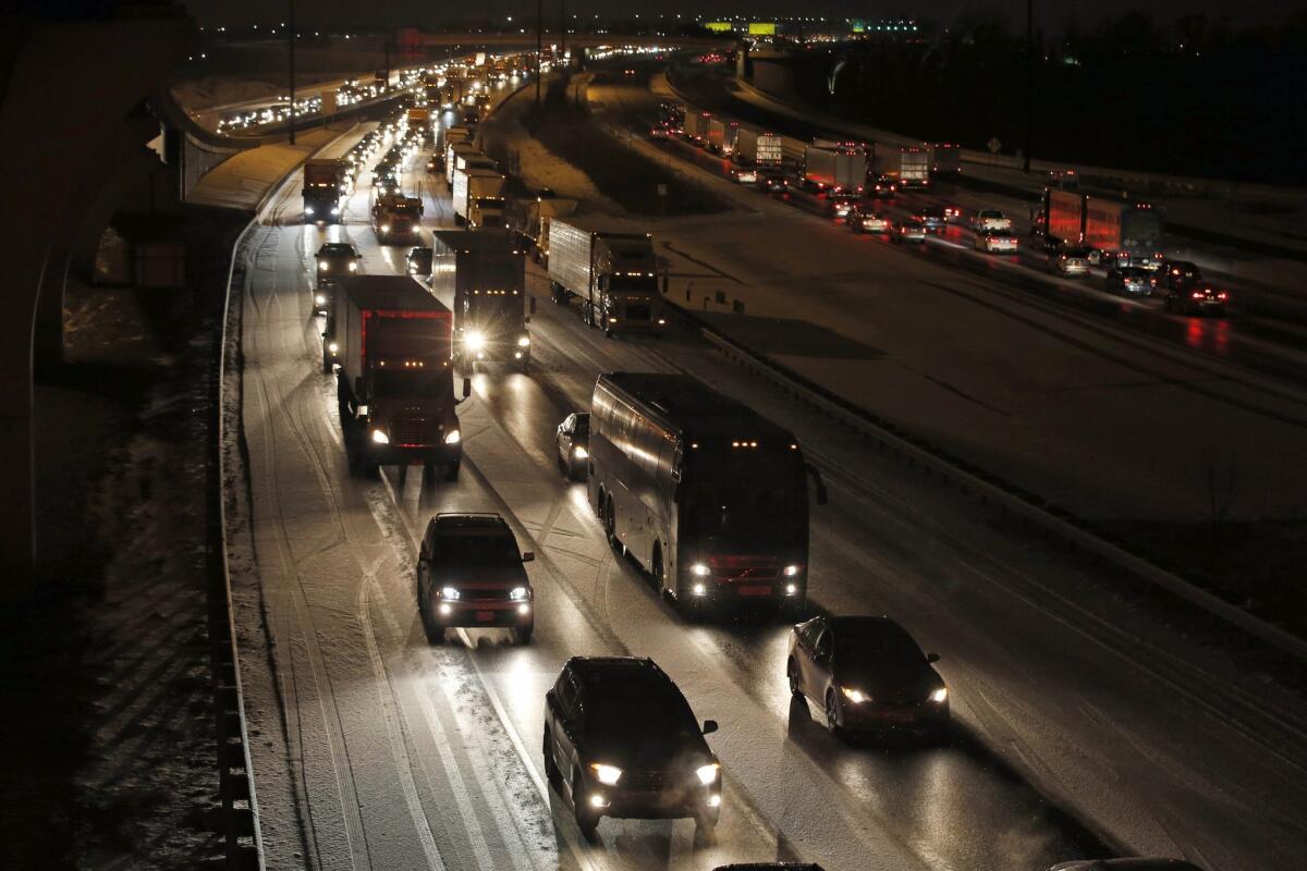 Traffic is slow on the outer loop of the I-495 Capital Beltway after snow fell Wednesday, a prelude to a much larger snowstorm due to hit late Friday.