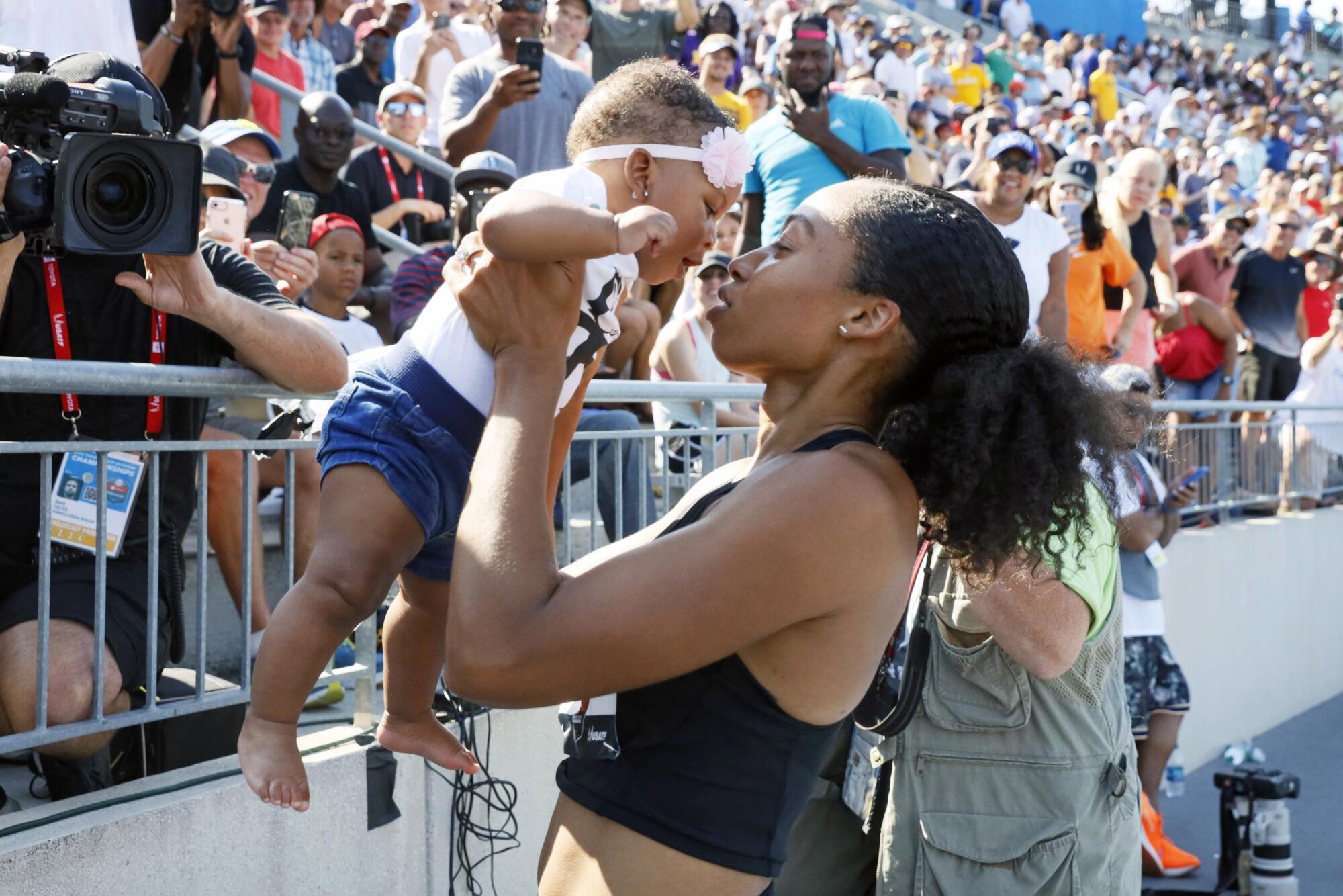 Allyson Felix holds her daughter, Camryn, after running in the 400 meters at the 2019 U.S. track and field championships.