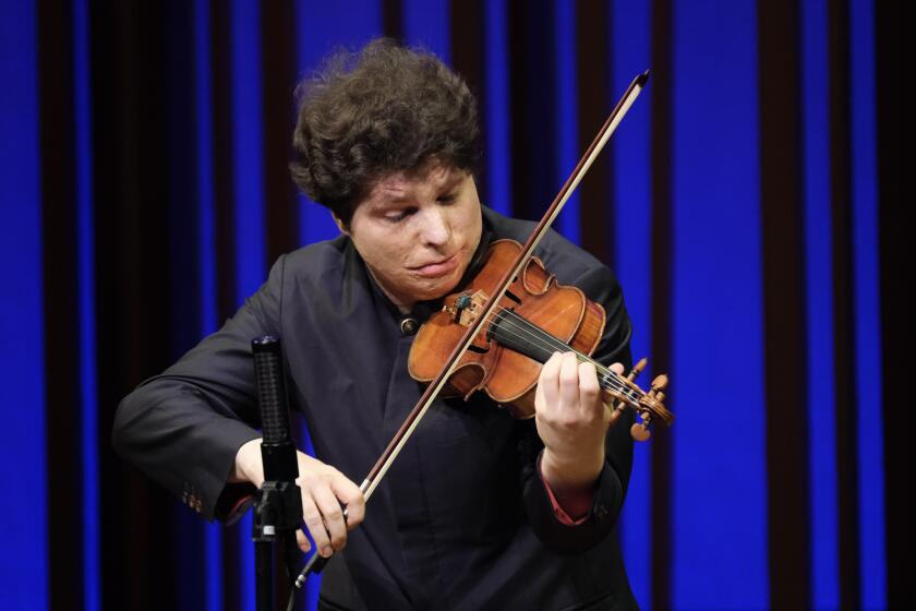 Violinist Augustin Hadelich, center, performed as part the "Unsilenced Voices" concert at SummerFest in La Jolla on Aug. 25.