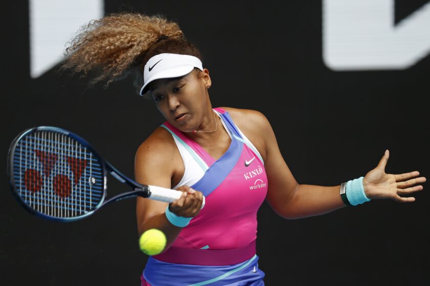 Naomi Osaka of Japan plays a forehand return to Camila Osorio of Colombia during their first round match.