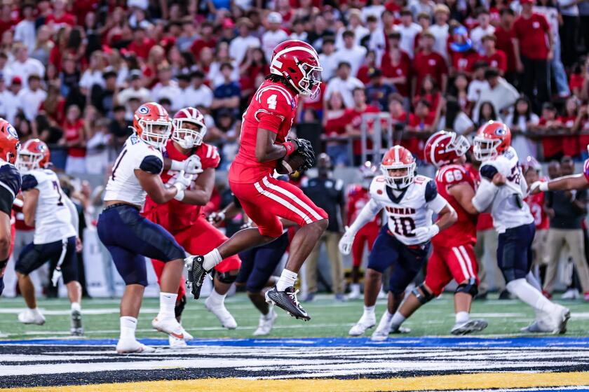 Mater Dei receiver Kayden Dixon-Wyatt makes a catch over the middle against Bishop Gorman on Fridy night at Santa Ana Stadium