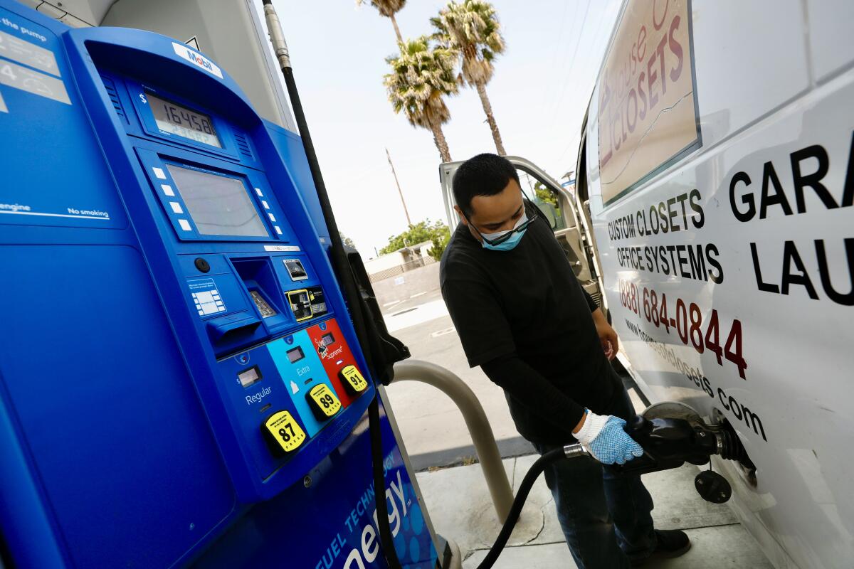 A man fills up his vehicle's fuel tank in Los Angeles. 