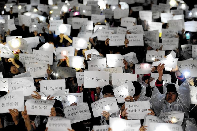 Students at Danwon High School in Ansan, South Korea, hold up messages for schoolmates missing in the ferry disaster.