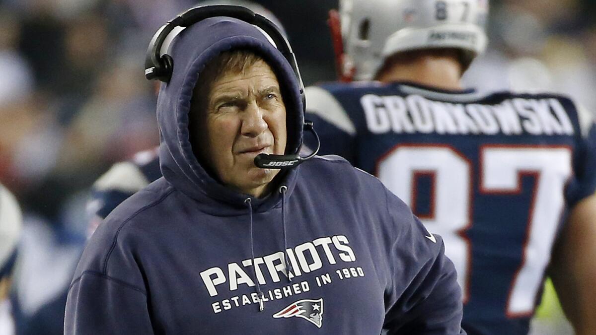 New England Patriots Coach Bill Belichick watches from the sidelines during the team's 45-7 victory over the Indianapolis Colts in the AFC Championship game Sunday. Belichick said the Patriots will fully cooperate with the NFL's investigation.