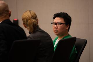 Yuhao Du, 25, who is accused of shooting a CHP officer during rush hour on Interstate 8 in Mission Valley on April 27, speaks to his attorneys during a preliminary hearing at the San Diego Central Courthouse on Friday, Nov. 18, 2022.