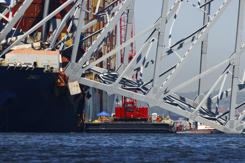 Salvage work continues on the collapsed Francis Scott Key Bridge, Monday, April 15, 2024, in Baltimore. The FBI confirmed that agents were aboard the Dali conducting court-authorized law enforcement activity. (AP Photo/Julia Nikhinson)