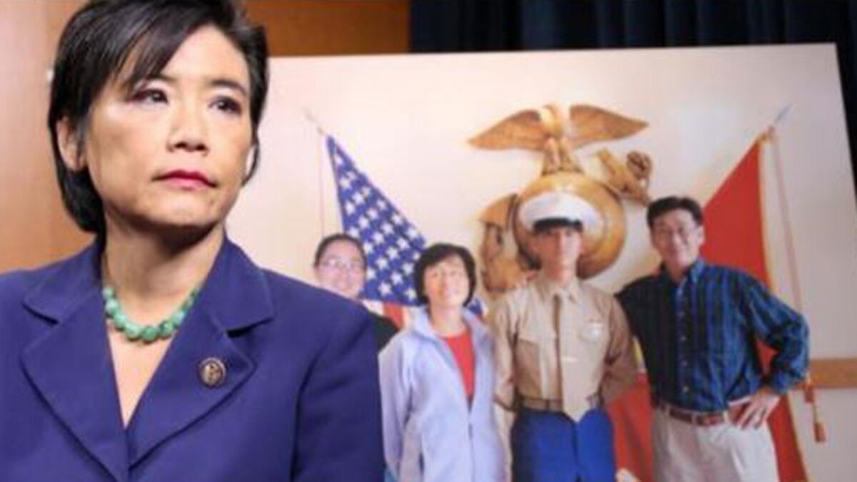 Rep. Judy Chu stands in front of a photo of her nephew, Lance Cpl. Harry Lew, and his family. Lew killed himself in Afghanistan after being hazed by his fellow Marines and Chu is trying to pass legislation to stop military hazing.