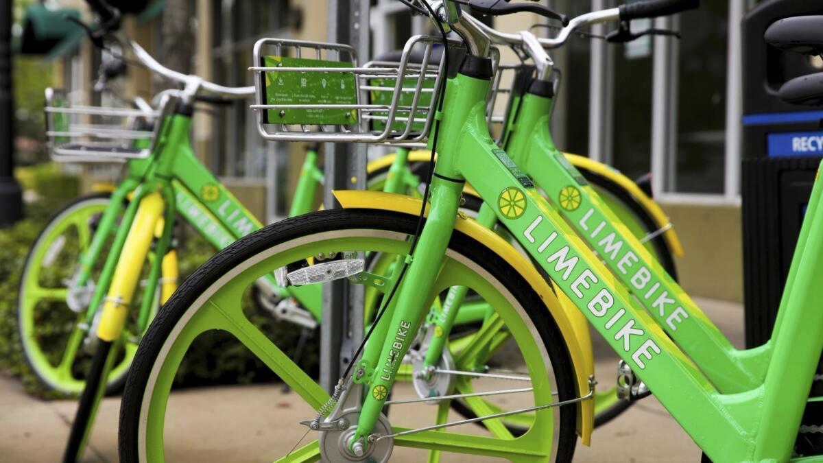 LimeBikes commuter bikes sit parked near the Miami Shores Business District in Miami.