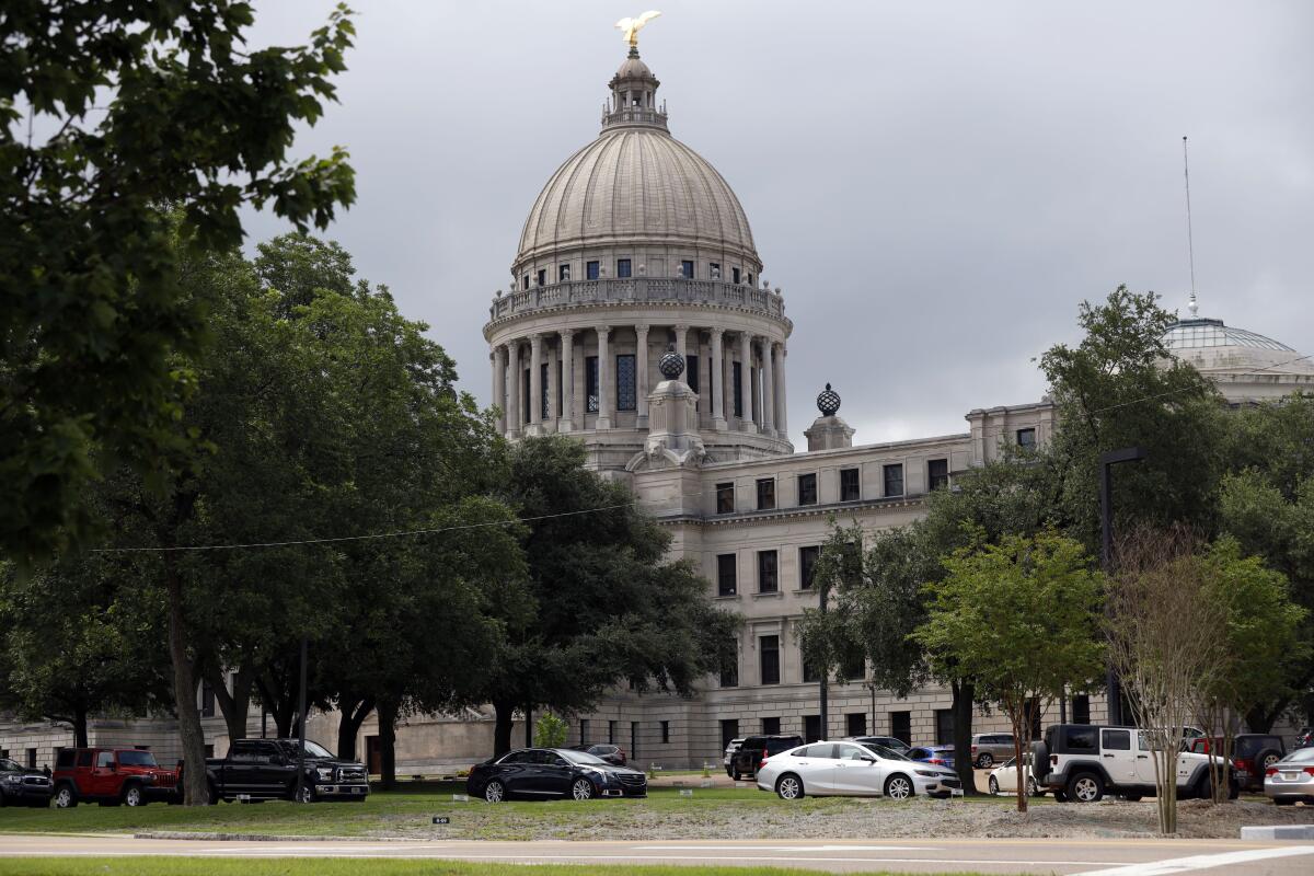 Cars line up at a drive-through COVID-19 testing center on the Capitol grounds in Jackson, Mississippi