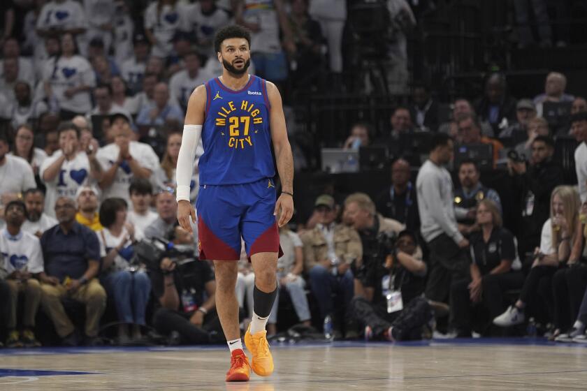Denver Nuggets guard Jamal Murray walks on the court during the first half of Game 6 of the team's NBA basketball second-round playoff series against the Minnesota Timberwolves, Thursday, May 16, 2024, in Minneapolis. (AP Photo/Abbie Parr)