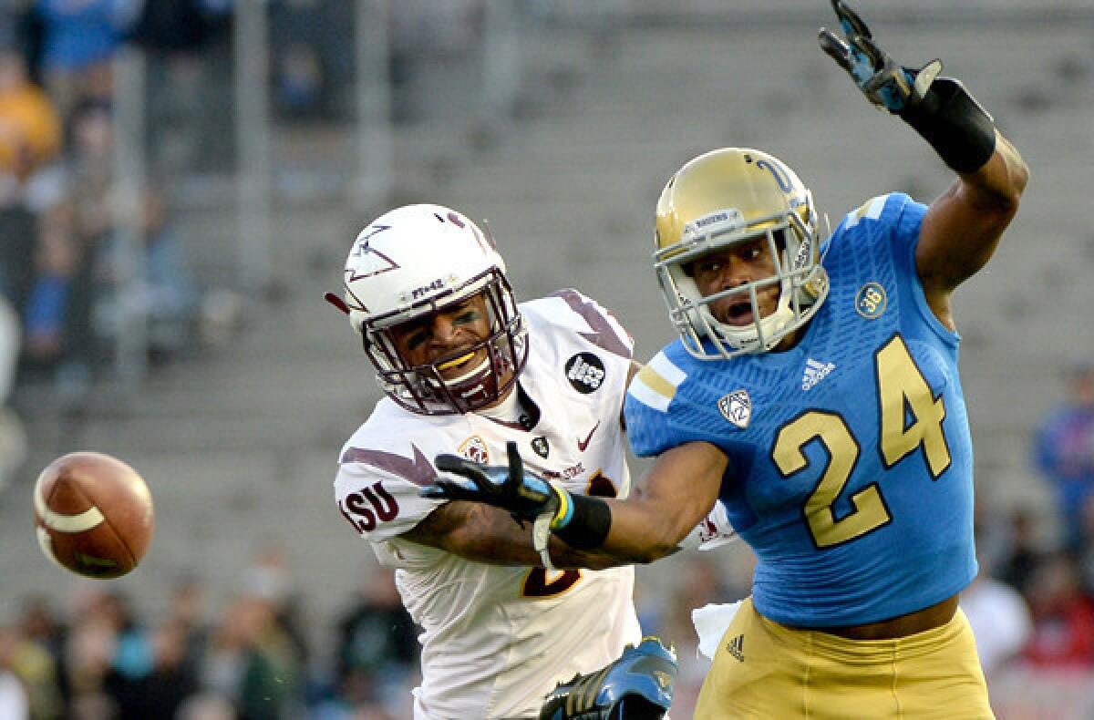 UCLA defensive back Ishmael Adams breaks up a pass intended for Arizona State receiver Jaelen Strong in the first quarter Saturday at Rose Bowl.