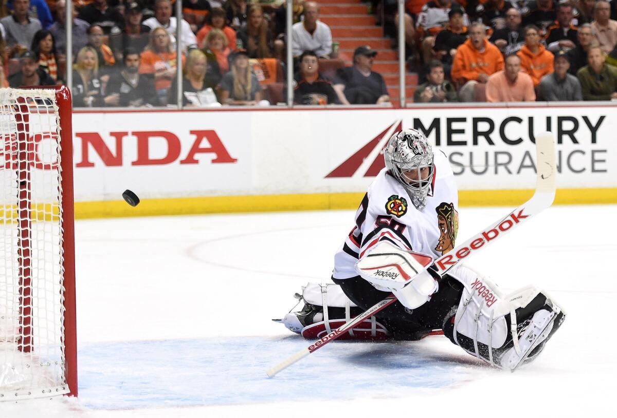 A shot from Ducks defenseman Cam Fowler streaks past Blackhawks goalie Corey Crawford during the first period of Game 5 of the Western Conference finals.