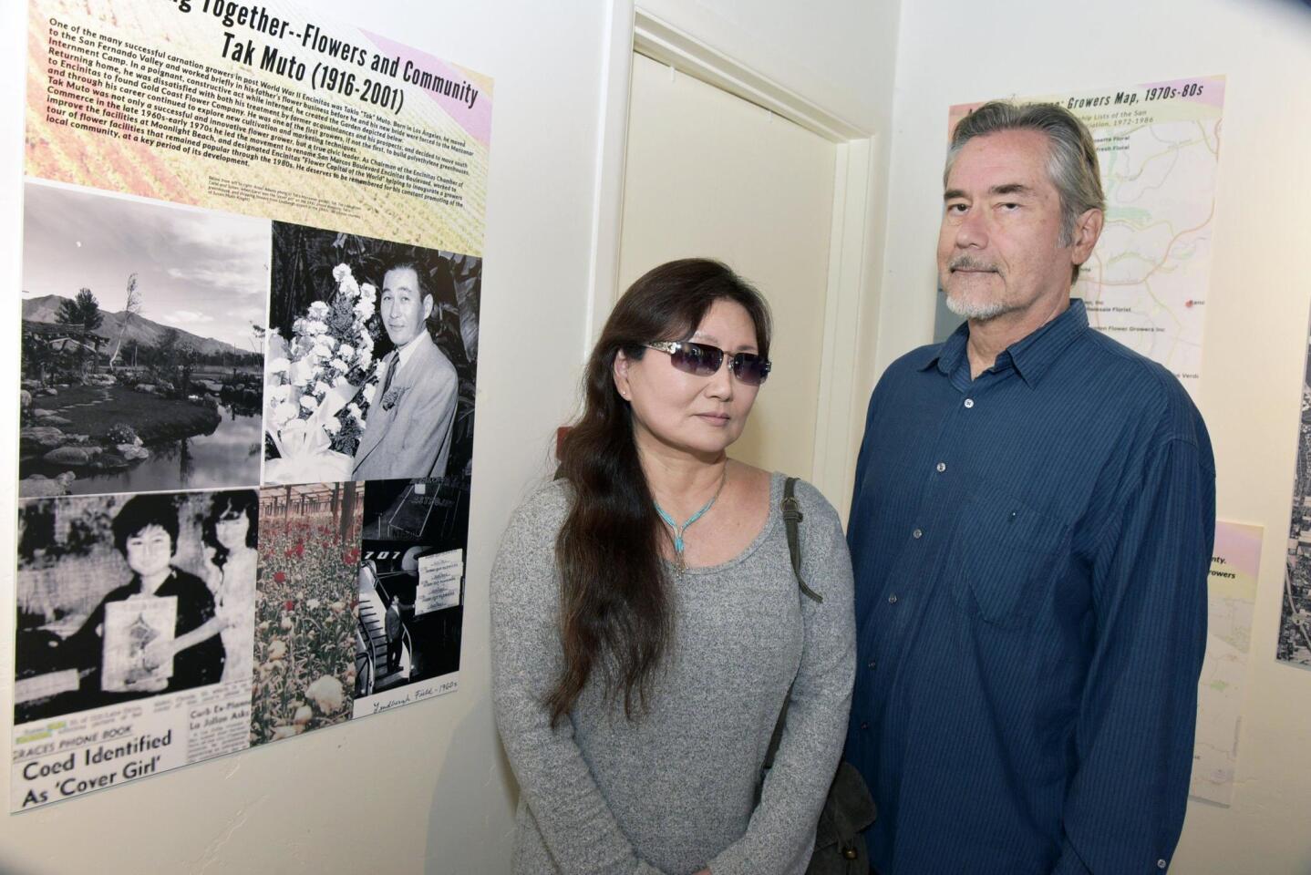 Susan Muto Knight (she is the little girl in the photo) and Anthony Knight next to the exhibit honoring her father, Tak Muto