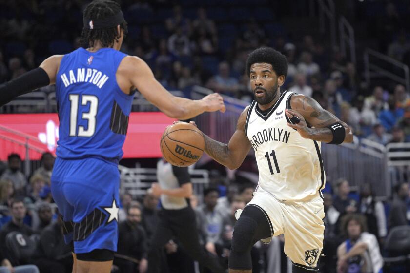 Brooklyn Nets guard Kyrie Irving (11)  drives against Orlando Magic guard R.J. Hampton (13) 