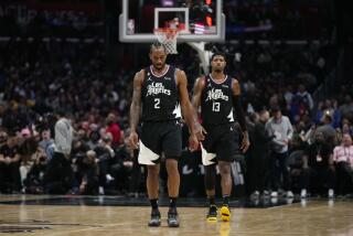 Los Angeles Clippers' Kawhi Leonard (2) and Paul George (13) walk on the court during the second half of an NBA basketball game against the Golden State Warriors Wednesday, March 15, 2023, in Los Angeles.(AP Photo/Jae C. Hong)