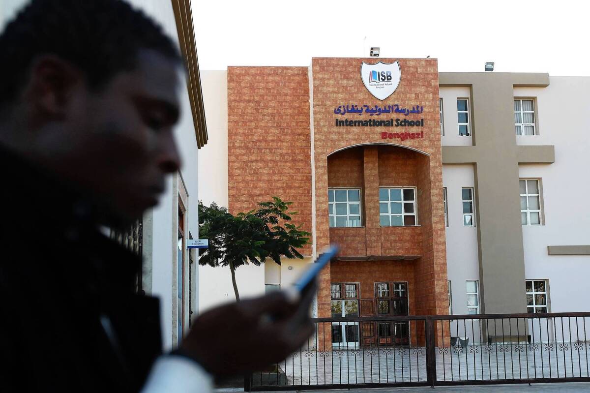 A man walks by the International School in Benghazi, Libya, where Ronnie Smith taught chemistry.