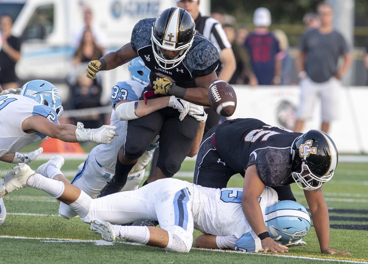 Corona del Mar defensive end Jack Rottler (33) causes a fumble during a nonleague game against JSerra on Aug. 17, 2018.