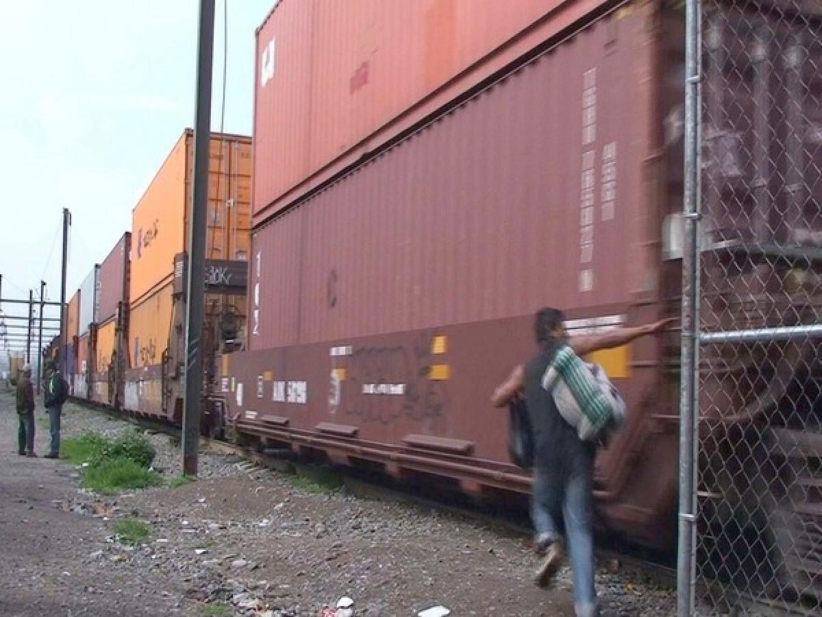 A 20-year-old Honduran attempts to board a train in Tultitlan on the outskirts of Mexico City.