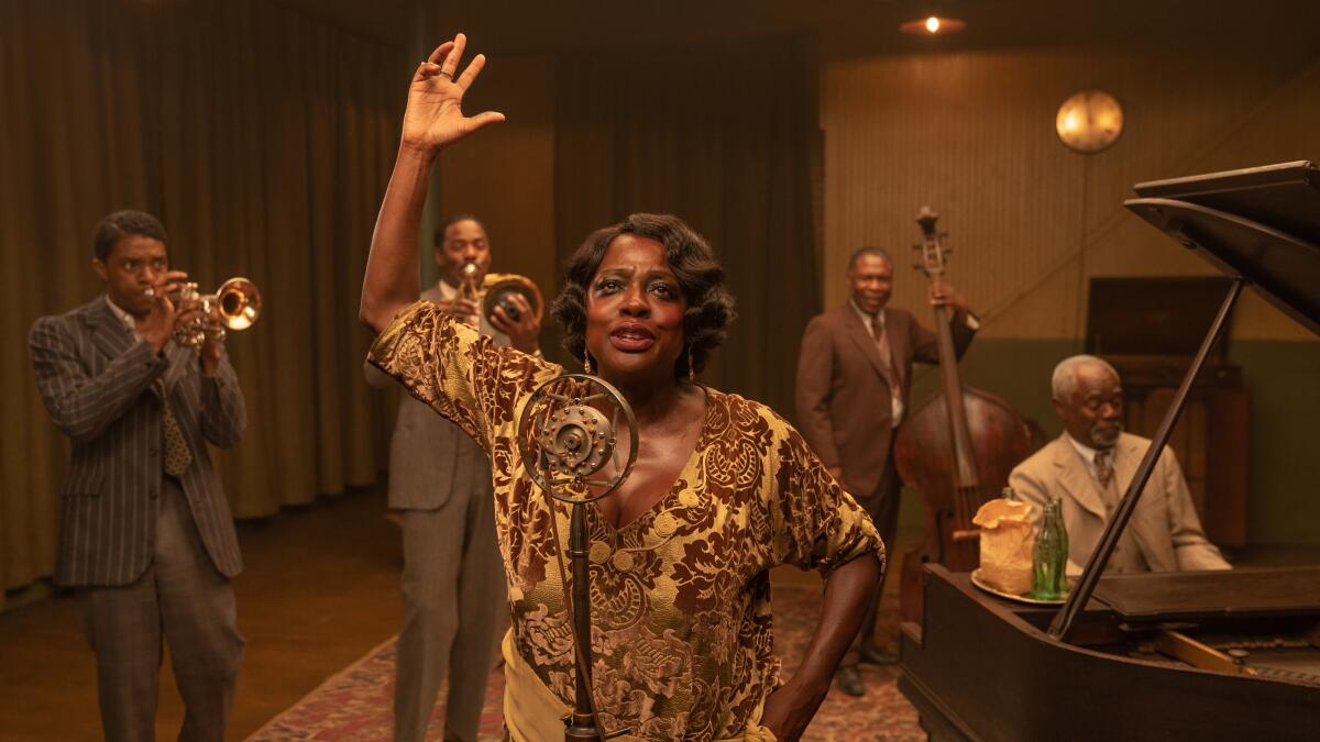 Viola Davis sings at a microphone, backed by a band, in "Ma Rainey's Black Bottom."